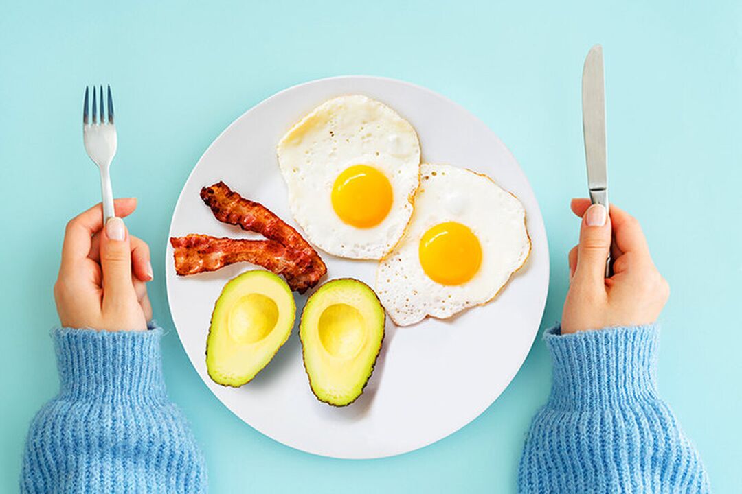 Perfect breakfast in the keto diet menu - eggs with bacon and avocado